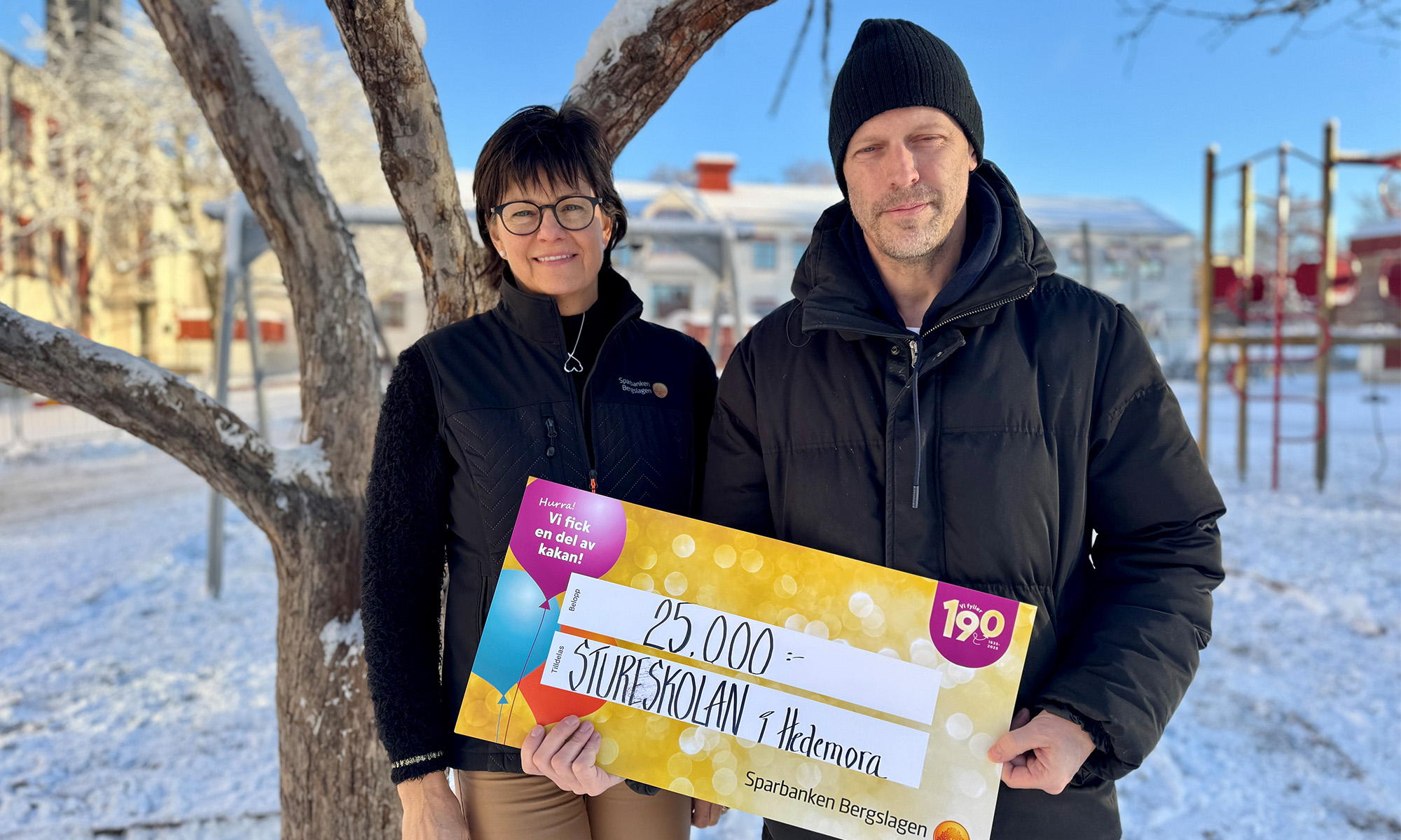 En man från Stureskolan håller i en vinnarcheck.